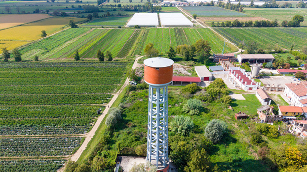 Aerial view of a water tower surrounded by agricultural fields and greenhouses in Mediglia Lombardy Italy. Aerial view of a water tower surrounded by agricultural fields and greenhouses in Mediglia Lombardy Italy.