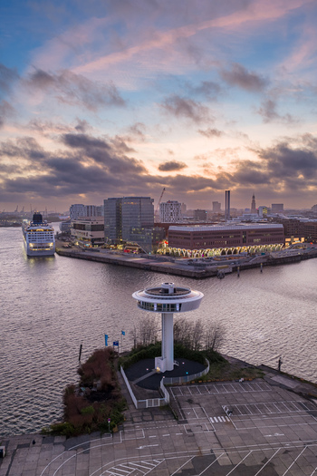 Aerial view of Lighthouse Zero with a cruise ship docked in the harbor and the city skyline under a colorful sunset sky Hamburg Hamburg Germany. Aerial view of Lighthouse Zero with a cruise ship docked in the harbor and the city skyline under a colorful sunset sky Hamburg Hamburg Germany.