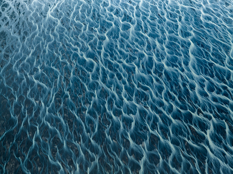 Aerial view of a riverbed painting an abstract masterpiece across the landscape its braided channels a dance of light and shadow Iceland Iceland. Aerial view of a riverbed painting an abstract masterpiece across the landscape its braided channels a dance of light and shadow Iceland Iceland.