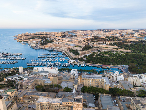 Aerial view of the historic fortifications and Grand Harbour in Valletta with numerous yachts and boats docked in the marina under a clear sky in Malta. Aerial view of the historic fortifications and Grand Harbour in Valletta with numerous yachts and boats docked in the marina under a clear sky in Malta.