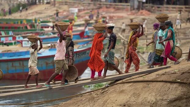 View of workers carrying baskets at Aminbazar Bangladesh. View of workers carrying baskets at Aminbazar Bangladesh.