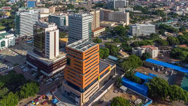 Accra Ghana 26 May 2023 Aerial view of the modern skyline in Accra featuring high rise office buildings lush green trees and urban streets. Accra Ghana 26 May 2023 Aerial view of the modern skyline in Accra featuring high rise office buildings lush green trees and urban streets.