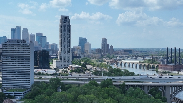 Aerial view of the city skyline bridges arching over the river and smokestacks standing tall against the sky Minneapolis Minnesota United States.