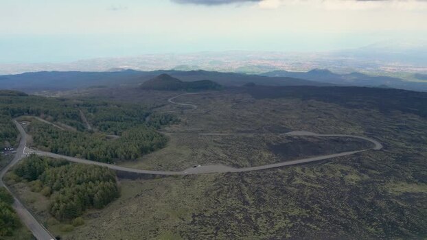 Aerial view of Mount Etna volcanic landscape and winding roads Italy. Aerial view of Mount Etna volcanic landscape and winding roads Italy.