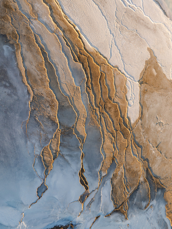 Aerial view of the Reykjanes peninsula landscape featuring intricate volcanic textures mineral deposits and rugged terrain patterns in Grindavikurbaer Iceland. Aerial view of the Reykjanes peninsula landscape featuring intricate volcanic textures mineral deposits and rugged terrain patterns in Grindavikurbaer Iceland.