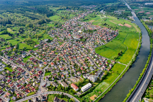 Aerial view of the residential district of Buckenhofen with houses green fields and the Main Donau Kanal under a clear sky in Forchheim Bayern Germany. Aerial view of the residential district of Buckenhofen with houses green fields and the Main Donau Kanal under a clear sky in Forchheim Bayern Germany.