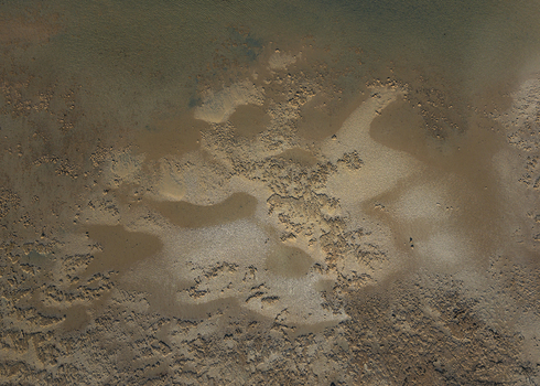 Aerial view of intricate sand patterns and shallow tidal waters along the coastline in Denham Western Australia Australia. Aerial view of intricate sand patterns and shallow tidal waters along the coastline in Denham Western Australia Australia.