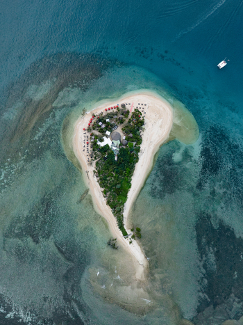 Aerial view of the heart shaped island fringed by white sand and turquoise waters a tropical haven gleaming under the sun Noum&eacute;a Province Sud New Caledonia.