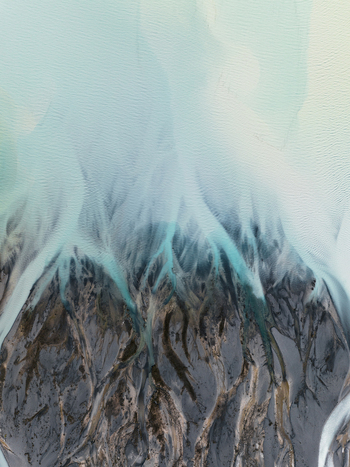 Aerial view of braided rivers carving through the rugged terrain displaying a mesmerizing blend of turquoise waters and dark rocks Lake Tekapo Canterbury Region New Zealand. Aerial view of braided rivers carving through the rugged terrain displaying a mesmerizing blend of turquoise waters and dark rocks Lake Tekapo Canterbury Region New Zealand.