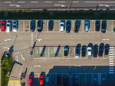 Aerial view of Logistikzentrum Allhaming with rows of parked cars in a paved parking lot marked parking spaces and road markings in Allhaming Oberosterreich Austria. Aerial view of Logistikzentrum Allhaming with rows of parked cars in a paved parking lot marked parking spaces and road markings in Allhaming Oberosterreich Austria.