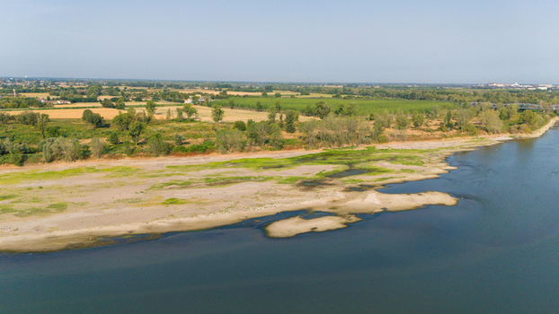 Aerial view of the Po River with low water levels caused by a summer heatwave exposing sandy riverbeds and sediments along the banks Castelvetro Piacentino Emilia Romagna Italy. Aerial view of the Po River with low water levels caused by a summer heatwave exposing sandy riverbeds and sediments along the banks Castelvetro Piacentino Emilia Romagna Italy.