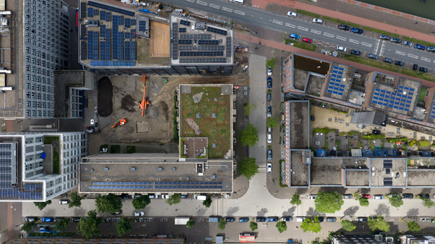 Aerial view of sustainable housing featuring green rooftop gardens solar panels and urban biodiversity in a modern district Amsterdam North Holland Netherlands. Aerial view of sustainable housing featuring green rooftop gardens solar panels and urban biodiversity in a modern district Amsterdam North Holland Netherlands.
