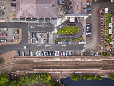 Aerial view of MediaCityUK in Salford showing the parking lot nearby railway tracks and surrounding urban infrastructure in Salford England United Kingdom. Aerial view of MediaCityUK in Salford showing the parking lot nearby railway tracks and surrounding urban infrastructure in Salford England United Kingdom.