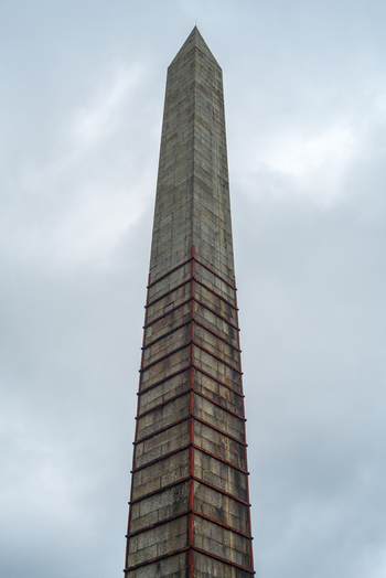 View of the Bodmin Beacon stone obelisk monument rising against a cloudy sky in Bodmin Cornwall United Kingdom. View of the Bodmin Beacon stone obelisk monument rising against a cloudy sky in Bodmin Cornwall United Kingdom.