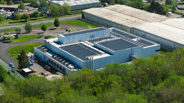 Aerial view of the Data Centre facility featuring rooftop solar panels and industrial cooling systems in Wellingborough England United Kingdom. Aerial view of the Data Centre facility featuring rooftop solar panels and industrial cooling systems in Wellingborough England United Kingdom.