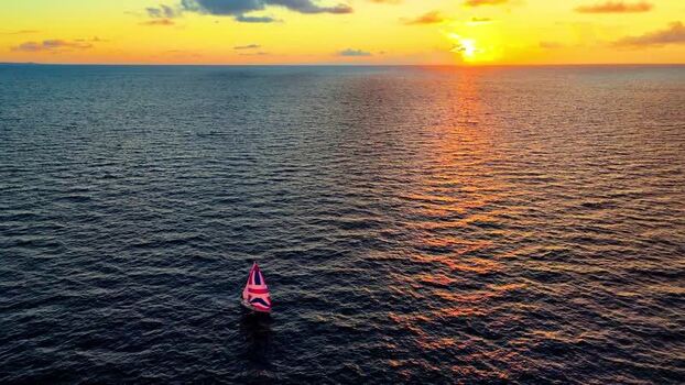 Aerial view of a sailboat at sunset in Kawaihae United States. Aerial view of a sailboat at sunset in Kawaihae United States.