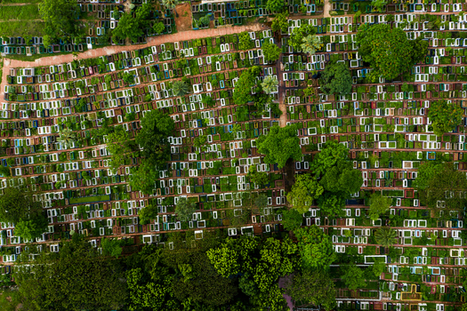Aerial view of the dense cemetery with numerous graves and lush green trees in Dhaka Dhaka Division Bangladesh.