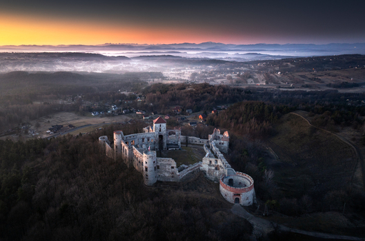 Aerial view of the historic Lipowiec Castle ruins on a hill in the Krakow Czestochowa Upland during a misty sunrise Krakow County Lesser Poland Poland. Aerial view of the historic Lipowiec Castle ruins on a hill in the Krakow Czestochowa Upland during a misty sunrise Krakow County Lesser Poland Poland.