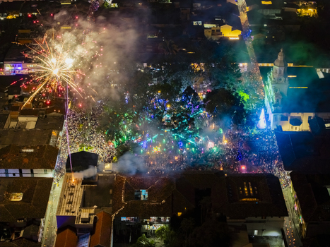Aerial view of a vibrant explosion of light and sound over the town square where fireworks illuminate the historic church and the lively crowd below Salamina Caldas Colombia. Aerial view of a vibrant explosion of light and sound over the town square where fireworks illuminate the historic church and the lively crowd below Salamina Caldas Colombia.