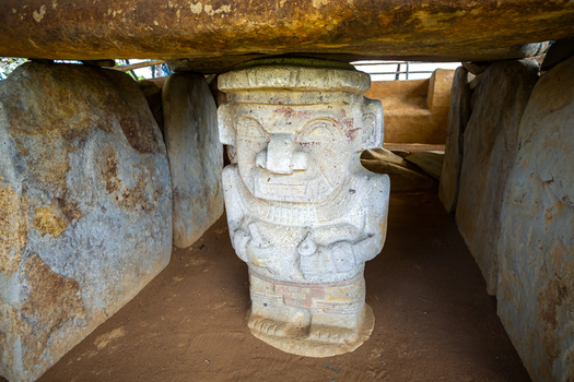 View of an ancient monolithic stone statue inside a burial chamber at San Agustin Archaeological Park in San Agustin Huila Colombia.
