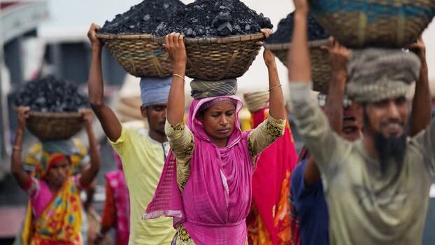 View of workers carrying coal baskets in Aminbazar Bangladesh.