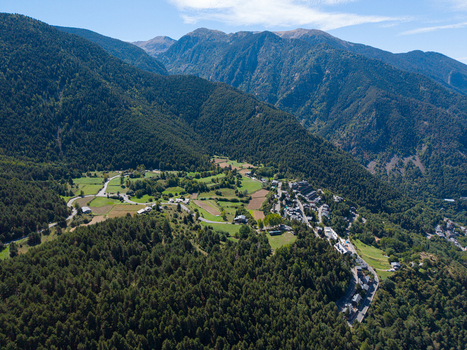 Aerial view of the village of Engolasters surrounded by lush green mountains and dense pine forests in Engolasters Escaldes Engordany Andorra. Aerial view of the village of Engolasters surrounded by lush green mountains and dense pine forests in Engolasters Escaldes Engordany Andorra.