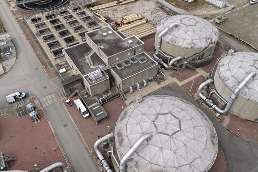 Aerial view of the Richmond Wastewater Treatment Plant featuring large circular digester tanks industrial buildings and service vehicles in Richmond British Columbia Canada. Aerial view of the Richmond Wastewater Treatment Plant featuring large circular digester tanks industrial buildings and service vehicles in Richmond British Columbia Canada.