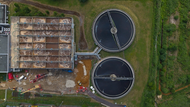 Aerial view of the water treatment facility at Palm Paper Factory featuring circular clarifiers and rectangular aeration tanks in King s Lynn England United Kingdom.