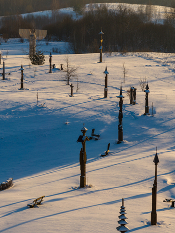 Aerial view of the Hill of Angels featuring wooden sculptures and crosses on a snow covered landscape with long shadows in Traku rajonas Vilniaus apskritis Lithuania. Aerial view of the Hill of Angels featuring wooden sculptures and crosses on a snow covered landscape with long shadows in Traku rajonas Vilniaus apskritis Lithuania.