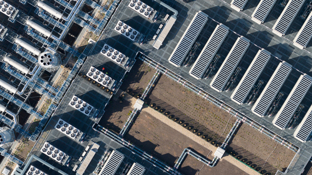 Aerial view of a large industrial facility featuring rows of cooling units complex piping networks and rooftop infrastructure in Dietzenbach Hessen Germany. Aerial view of a large industrial facility featuring rows of cooling units complex piping networks and rooftop infrastructure in Dietzenbach Hessen Germany.