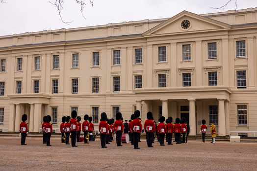 London United Kingdom 12 May 2025 View of the King s Guard in red tunics and bearskin hats standing in formation in front of the Horse Guards building.