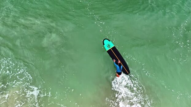 Aerial view of surfer in the ocean Indonesia.