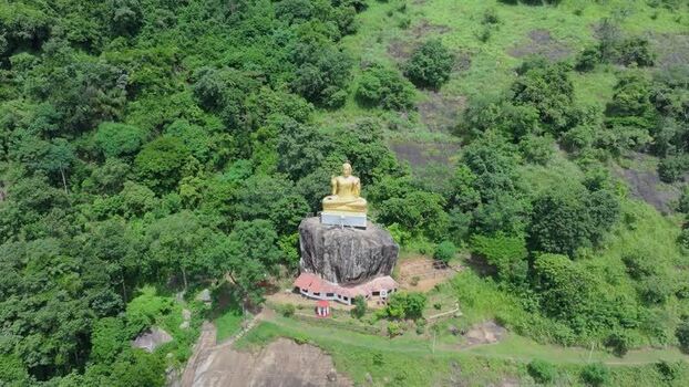 Aerial view of golden Buddha statue in Kandy Sri Lanka.