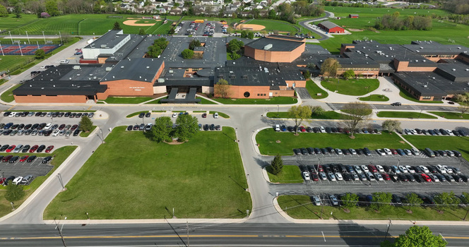 Aerial view of Susquehannock High School featuring brick buildings extensive parking lots and surrounding athletic fields in New Freedom Pennsylvania United States. Aerial view of Susquehannock High School featuring brick buildings extensive parking lots and surrounding athletic fields in New Freedom Pennsylvania United States.