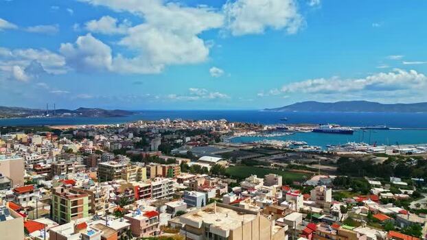 Aerial view of a coastal town and harbor in Greece.