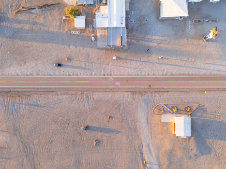 Amboy United States 06 April 2026 Aerial view of the stark sun drenched landscape where buildings cast long shadows on the desert sand along the route 66 National Trails Highway. Amboy United States 06 April 2026 Aerial view of the stark sun drenched landscape where buildings cast long shadows on the desert sand along the route 66 National Trails Highway.