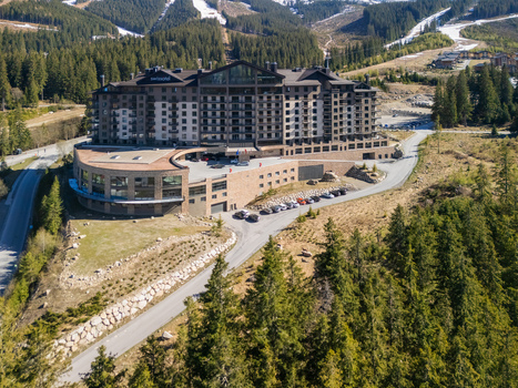 Aerial view of DAMIAN JASNA Hotel Resort Residences surrounded by coniferous forest and mountain slopes Demanovska Dolina Zilinsky kraj Slovakia. Aerial view of DAMIAN JASNA Hotel Resort Residences surrounded by coniferous forest and mountain slopes Demanovska Dolina Zilinsky kraj Slovakia.