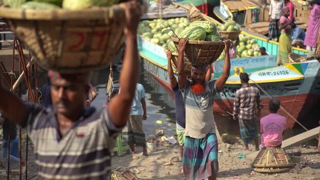View of workers carrying watermelons at Sadarghat Bangladesh.