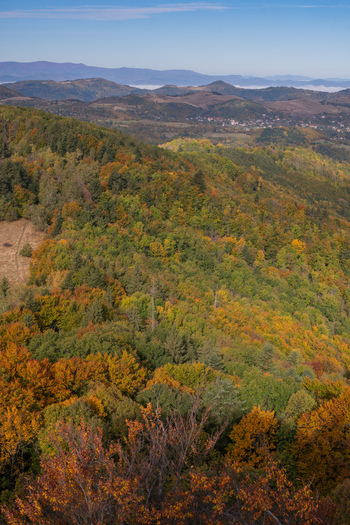 Aerial view of Sitno mountain area with vibrant autumn foliage dense forests rolling hills and distant ridges under a clear blue sky in Ilija Banska Bystrica Regio Slovakia. Aerial view of Sitno mountain area with vibrant autumn foliage dense forests rolling hills and distant ridges under a clear blue sky in Ilija Banska Bystrica Regio Slovakia.