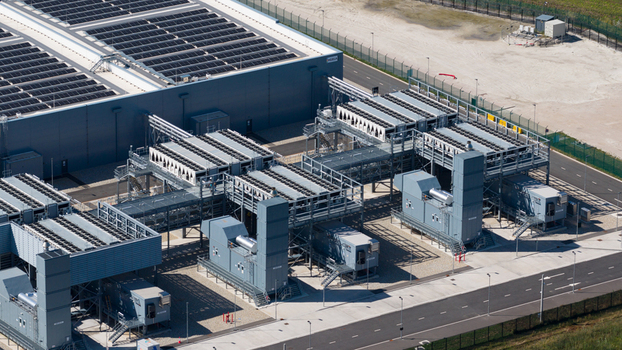 Aerial view of an industrial facility featuring rooftop solar panels and cooling infrastructure in Winschoten Groningen Netherlands.