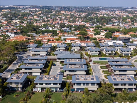 Aerial view of Quinta da Marinha residential area featuring modern villas with flat roofs and solar panels surrounded by lush gardens in Cascais Lisbon Portugal. Aerial view of Quinta da Marinha residential area featuring modern villas with flat roofs and solar panels surrounded by lush gardens in Cascais Lisbon Portugal.
