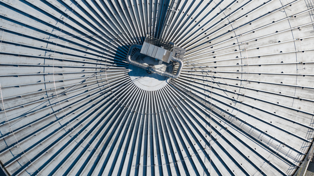 Aerial view of the Cosun Beet Company industrial facility featuring a large circular tank roof with radial structural beams in Groningen Groningen Netherlands. Aerial view of the Cosun Beet Company industrial facility featuring a large circular tank roof with radial structural beams in Groningen Groningen Netherlands.