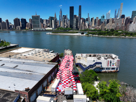Long Island City United States 13 June 2026 Aerial view of a massive red and white checkered Croatian flag displayed by fans on a pier with the Manhattan skyline in the background.
