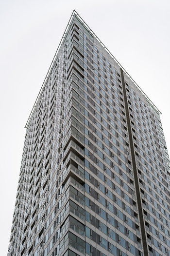 View of a modern glass skyscraper with balconies under an overcast sky in Bratislava Bratislava Region Slovakia. View of a modern glass skyscraper with balconies under an overcast sky in Bratislava Bratislava Region Slovakia.