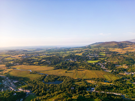 Aerial view of the village of Cwm y glo nestled among rolling green hills meadows and winding streams in Cwm y glo Wales United Kingdom. Aerial view of the village of Cwm y glo nestled among rolling green hills meadows and winding streams in Cwm y glo Wales United Kingdom.