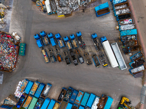 Aerial view of Neuenstein Techno Zone showing rows of parked trucks and trailers loaded with industrial scrap materials in a recycling facility in Neuenstein Baden Wurttemberg Germany. Aerial view of Neuenstein Techno Zone showing rows of parked trucks and trailers loaded with industrial scrap materials in a recycling facility in Neuenstein Baden Wurttemberg Germany.