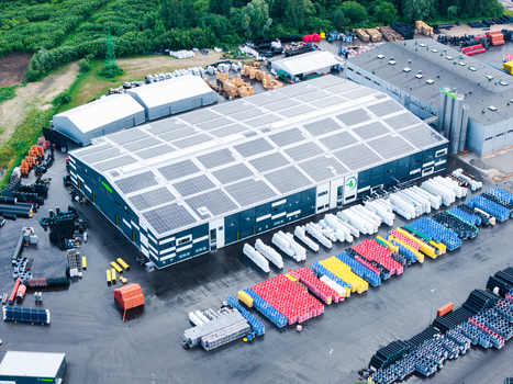 Jelgava Latvia 04 July 2026 Aerial view of the Evopipes manufacturing facility featuring industrial buildings with solar panels and rows of colorful plastic pipes stored in the yard.