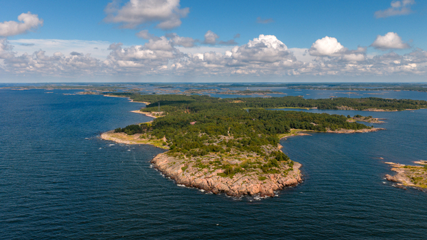 Aerial view of Oro Fortress Island surrounded by dense pine forests rocky coastlines and the deep blue waters of the Baltic Sea in Oro Varsinais Suomi Finland. Aerial view of Oro Fortress Island surrounded by dense pine forests rocky coastlines and the deep blue waters of the Baltic Sea in Oro Varsinais Suomi Finland.