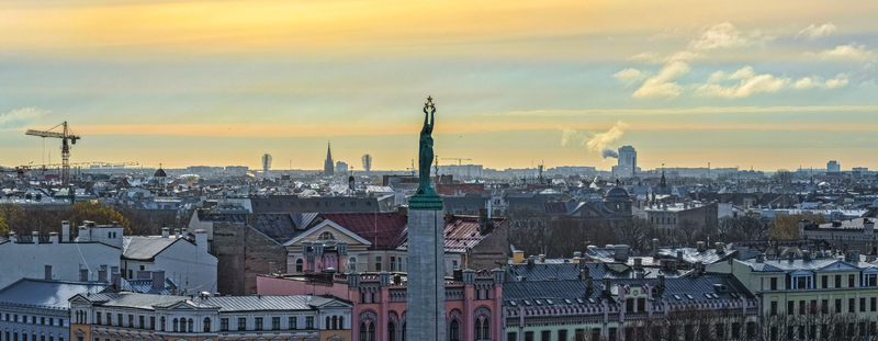 Aerial view of the Freedom Monument rising above the historic rooftops and urban skyline of Riga Latvia. Aerial view of the Freedom Monument rising above the historic rooftops and urban skyline of Riga Latvia.