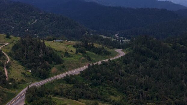 Aerial view of a winding highway through dense forests United States. Aerial view of a winding highway through dense forests United States.